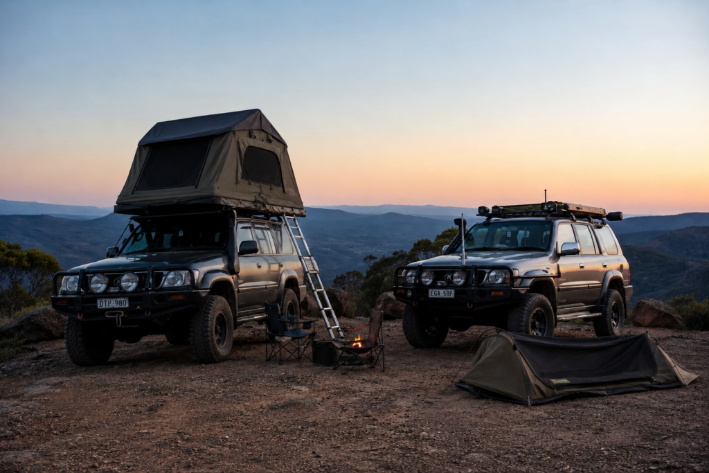 Two 4WD vehicles with rooftop tent and swag camping gear at sunset.