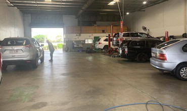 a selection of cars in a garage at Coleman Tyres and Mechanical in Wacol, QLD