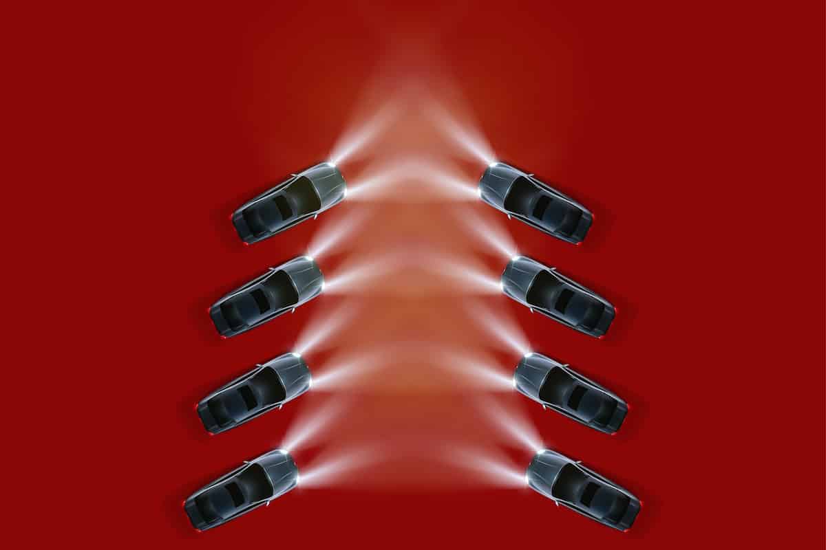 8 cars use their headlights to create an effect that looks like a Christmas tree