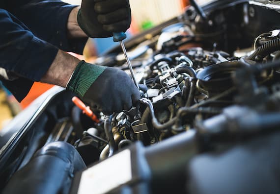 a close up of a mechanic's hands performing a car service